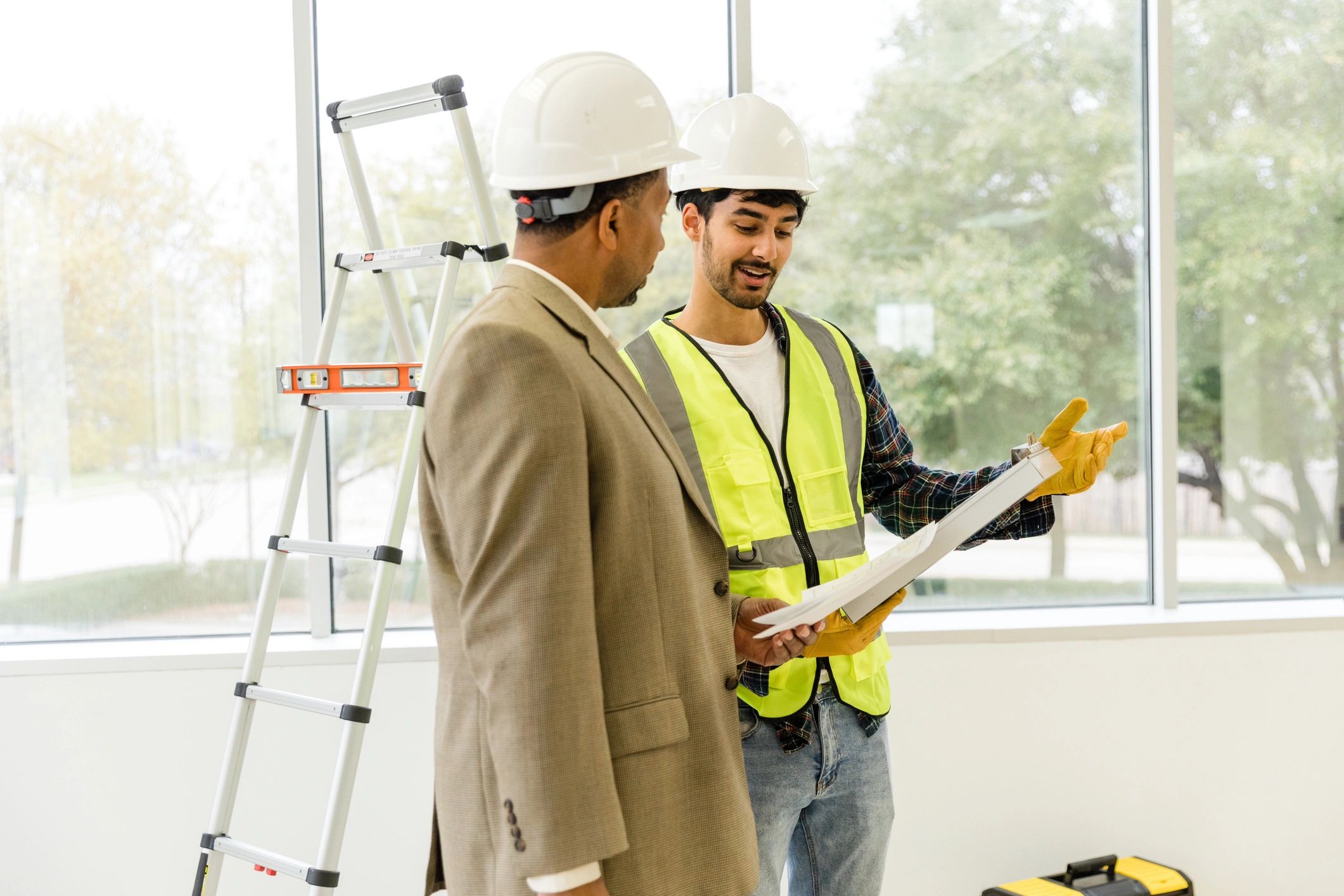 Contractor and foreman reviewing plans together