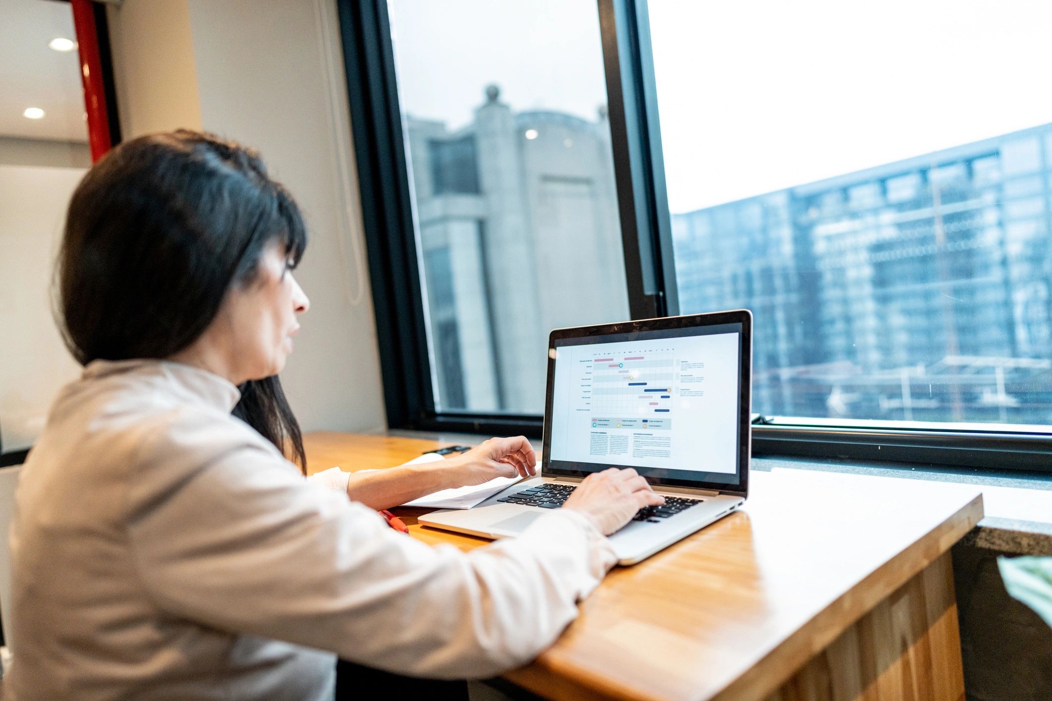 Project manager tracking tasks on a laptop